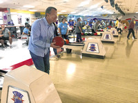 PINS AND NEEDLING: Good-natured supporters of child advocacy center bowl to support the cause