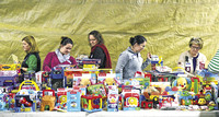 A profusion of presents: Volunteers, gifts fill exhibit hall for those in need